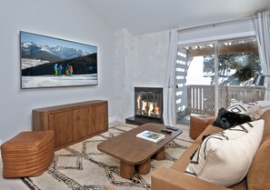 Comfy seating, cozy fireplace, and private balcony, with BBQ grill