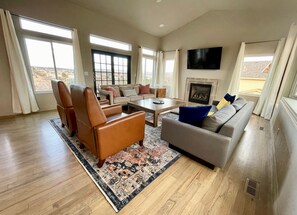 Main living room with 65" Roku TV and gas fireplace.
