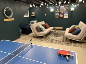 A mid-sized ping-pong table is in the basement for a little competitive fun.