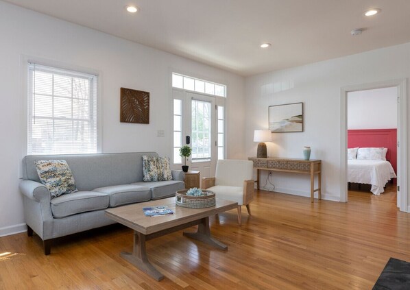 Welcome to Sunset Soiree! Living room with two bedrooms to the side.