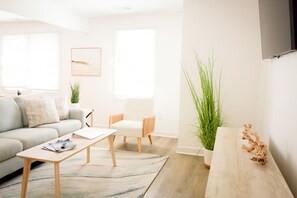 Open concept living and dining area with flat screen tv and room for all!