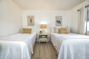 This room features a twin and a full bed, plenty of sleeping space for up to 3 kids, brand new memory foam mattresses, new bedding and soft, coastal decor.