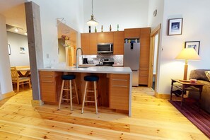 New kitchen w Stainless appliances and heated real wood floors in the kitchen, dining, and portions of the living room.