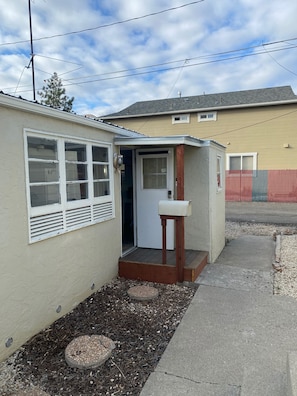 Front Entrance and Walkway to the Alleyway and Parking Stall