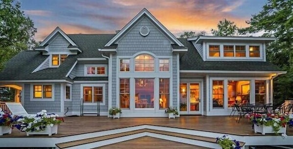 Lakeside of house with large deck