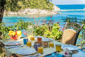Dine outside with stunning views of Loggos Bay