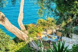 The balcony looking down to the terrace and sea below