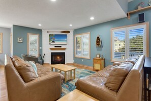 Enter on the Main Level where you'll find a spacious Living Area with comfortable furniture, a large Flat Screen TV, and an electric Fireplace waiting for you.