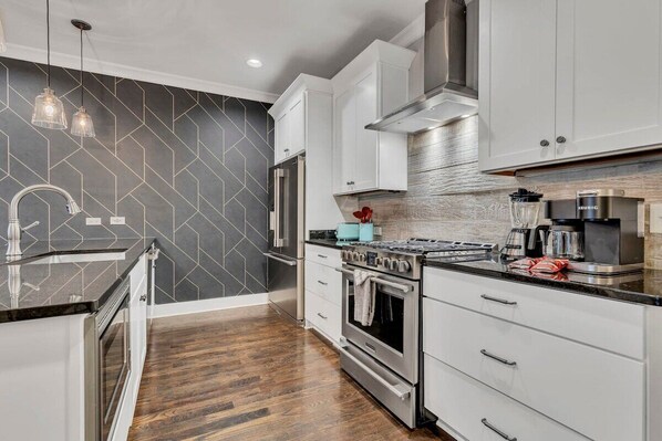 Welcome to your dream Nashville rental! This chic kitchen is perfect for brunches before exploring the city, making it ideal for bachelorette parties or family reunions. Enjoy luxury and comfort for your group—let the culinary adventures begin!