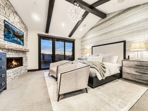 The first king suite is spacious and features a gas fireplace, a smart TV, access to the patio, and an incredible en-suite bathroom.
