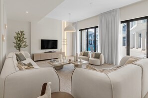 Lounge area with latest Samsung TV and JBL soundbar. Large bi folding doors opening onto the pool