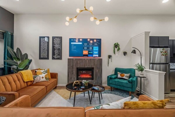 Imagine unwinding in this vibrant living space, where every detail is designed for your comfort. Enjoy the plush seating, warm fireplace, and stunning decor that creates an inviting ambiance perfect for any gathering.
