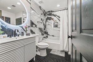Step into this spa-like bathroom designed for indulgence. You’ll appreciate the elegant marble tiles and modern fixtures, making every shower a luxurious experience. The perfect place to start and end your day refreshed and rejuvenated.