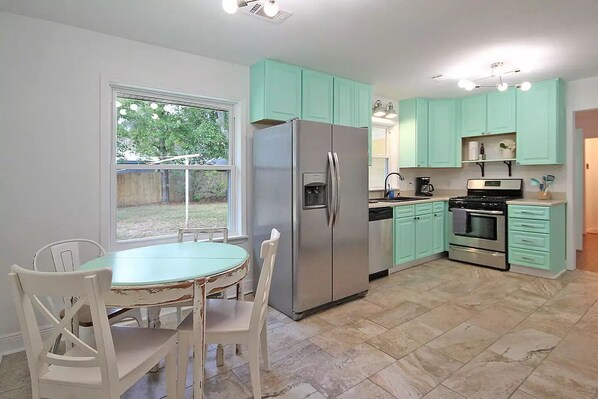 Beachy kitchen fully equipped with dining, utensils and glassware for 8 guests.