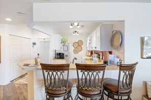 Great gathering spot in the kitchen with a center island and trendy bar stools.