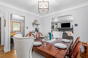 The wooden table and chairs in this dining room make it feel like a cozy and inviting space. The perfect place to enjoy a meal with family and friends.