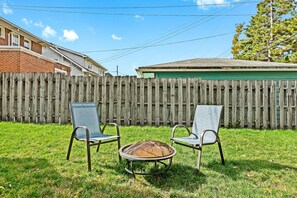 The backyard is equipped with a fire pit, perfect for roasting marshmallows or making s'mores.