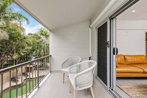 Relax with a glass of wine on your private balcony, enjoying views overlooking the pool and tropical gardens.    
