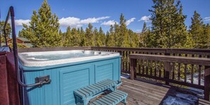 8 person Hot tub on the East deck on top floor under a blue sky or at night looking at  the  stars