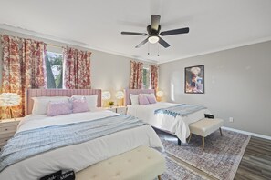 Bedroom with 2 double beds, ceiling fan, and windows