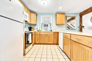 Kitchen with microwave, oven, fridge, dishwasher and coffee maker