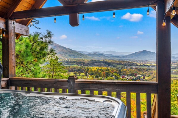 Indulge in relaxation in the private hot tub with an awe-inspiring mountain view, ensuring a serene end to your day in this beautiful retreat
