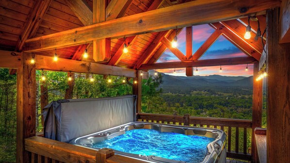 Indulge in relaxation in the private hot tub with an awe-inspiring mountain view, ensuring a serene end to your day in this beautiful retreat