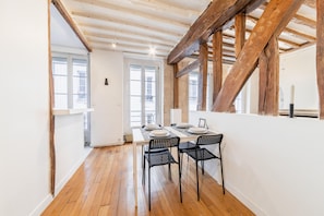 A bright living room with 4 large windows overlooking a quiet street.