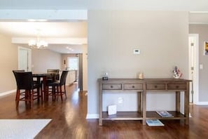 Picture from the living room looking at the open floor with the kitchen in the back.