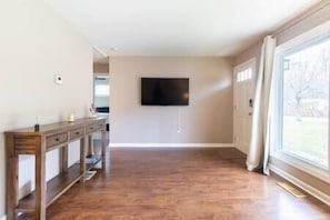 From the sofa in the living room looking at the 55" Roku tv. The front door is on the right.