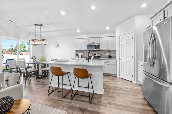 Enjoy coffee at the breakfast bar in this modern kitchen