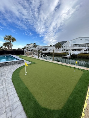 Putting green next to water