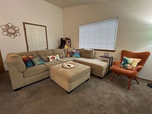 Living room, plush couch with chaise lounge and Ms. Pac-Man