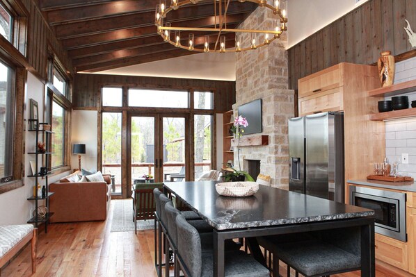 Spacious dining area with living room in the background