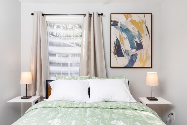 Queen bed with fluffy duvet and extra pillows