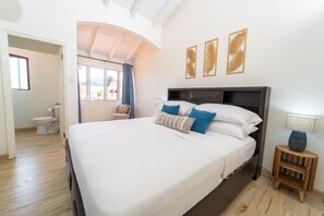 Master bedroom with king bed and contemporary en suite bathroom