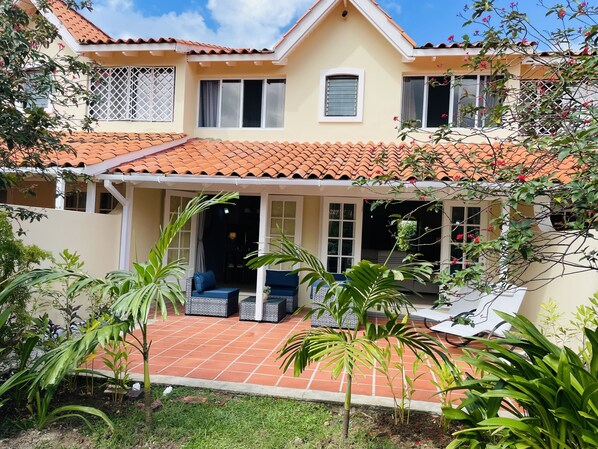 Rear of the property with a peaceful private patio.