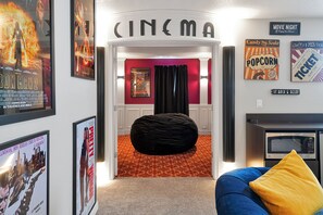 Theater entrance is themed like a classic cinema—red walls, wainscoting, and real atmosphere.