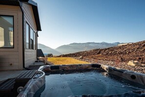 Enjoy the stunning mountain views while relaxing in the private hot tub. 