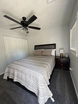 Queen Bed with nightlamp and ceiling fan to keep you cozy all year round