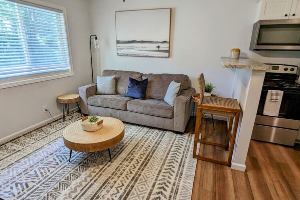 Living room with Ashley comfort sofa and bar top seating
