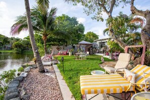 surrounded by the breathtaking beauty of towering trees and the serene backdrop of nature. As you gaze upon the picturesque canal, watch in wonder as graceful ducks glide by and flying fish gracefully dance through the water, creating a relaxing Zen.
