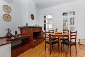 Living room with with A/C, ornamental fireplace, and dining area