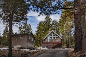 Street view of driveway, main house, 2 car garage and above garage studio. 