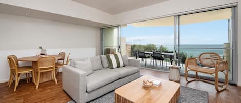 Upstairs living and dining space with balcony access and stunning views