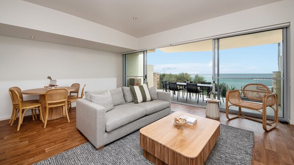 Upstairs living and dining space with balcony access and stunning views