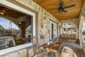 Outdoor furniture adds tasteful touches to the front porch, including a romantic swing!