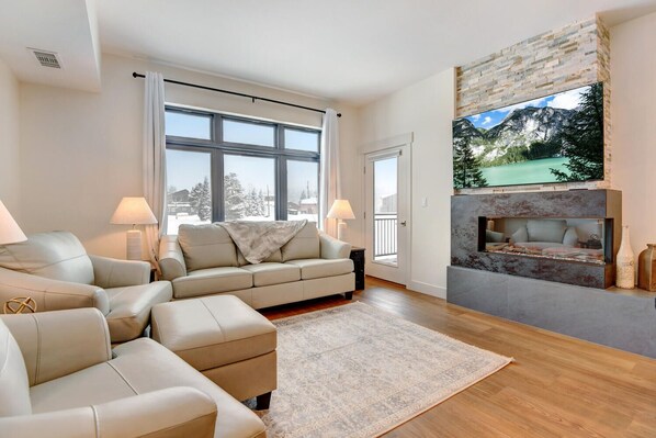 Cozy Living Room With 65" HD TV and Custom Color Changing fireplace