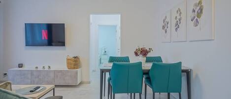 Dining table in the living room with access to TV & multimedia.