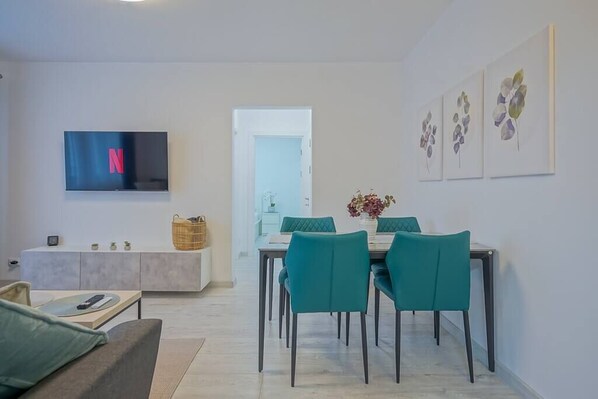 Dining table in the living room with access to TV & multimedia.